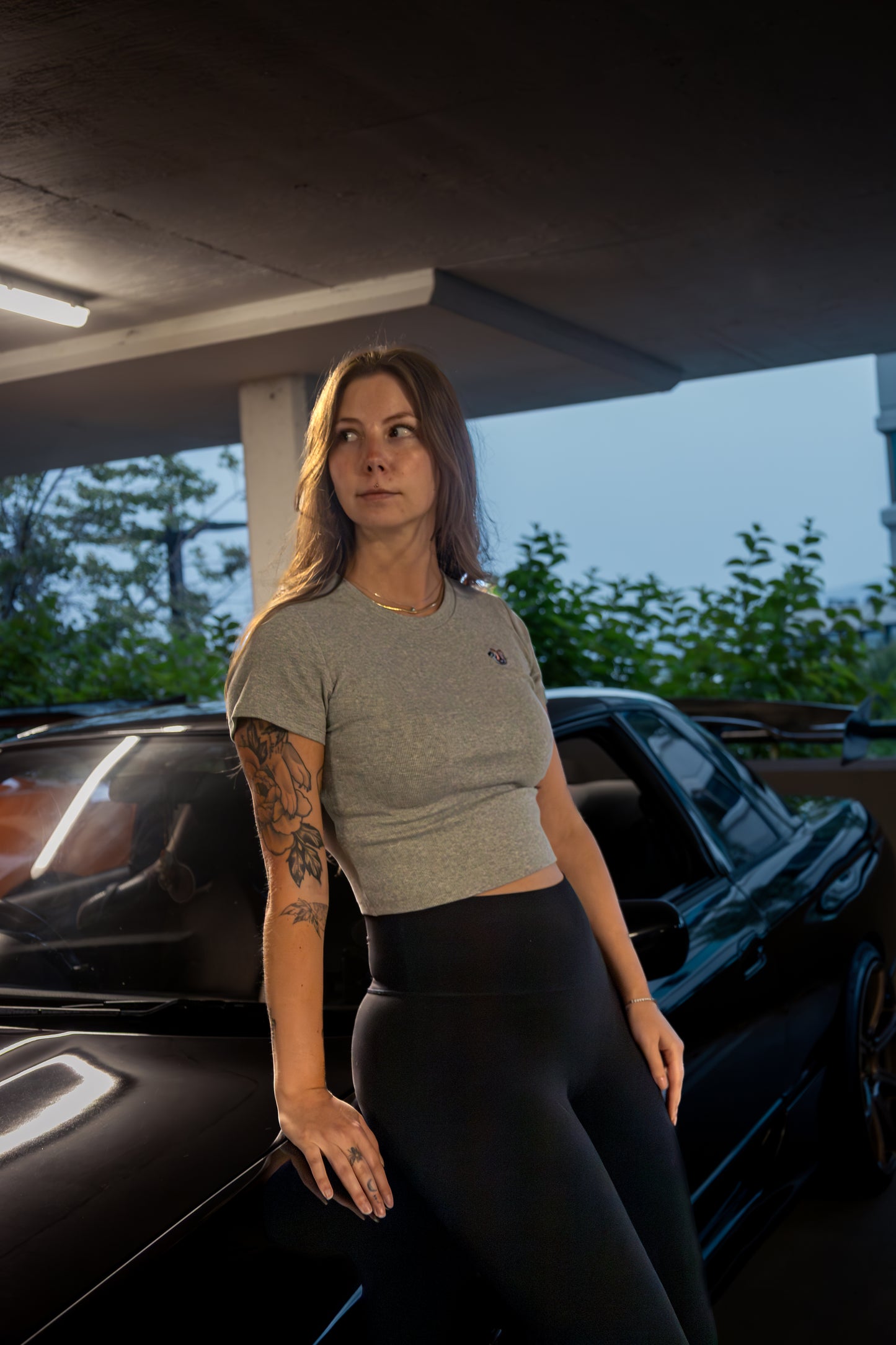 Woman wearing Lucid Auto Company Turbo Baby Tee – embroidered automotive streetwear for car enthusiasts