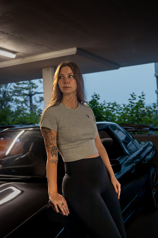 Woman wearing Lucid Auto Company Turbo Baby Tee – embroidered automotive streetwear for car enthusiasts