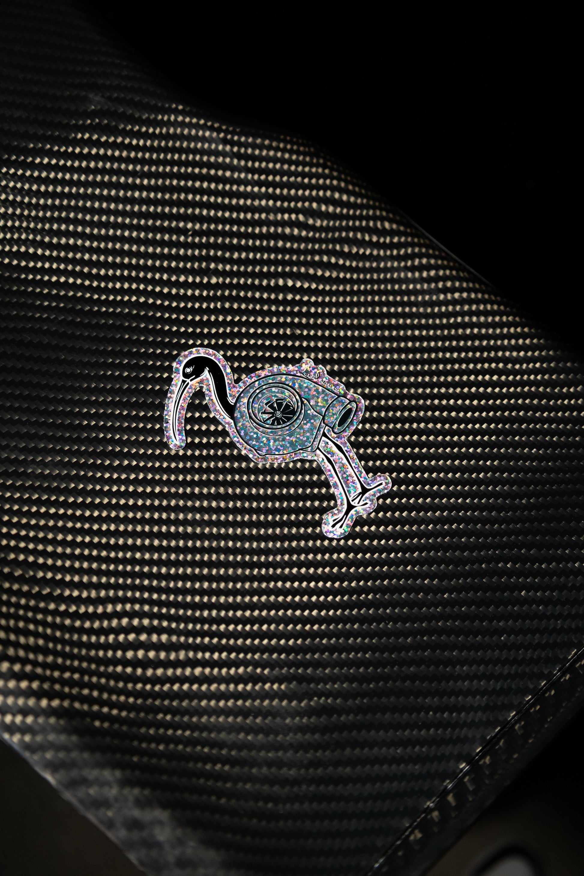 Close-up of glitter detail on Bin Chicken Turbo sticker – automotive accessory